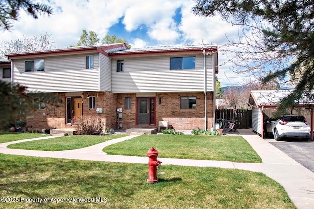 681 S 2nd St Unit A, Carbondale, CO 81623 - multi unit property featuring fence, a front lawn, brick siding, and a carport