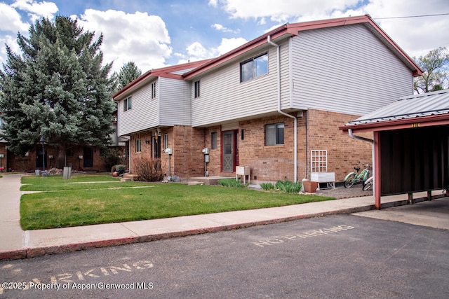 681 S 2nd St Unit A, Carbondale, CO 81623 - view of front of house with a front lawn and brick siding