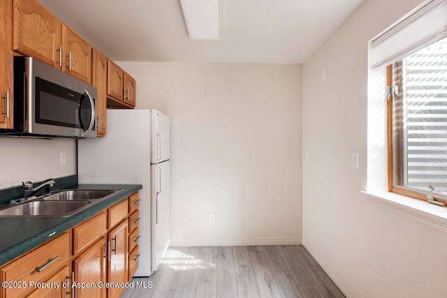 681 S 2nd St Unit A, Carbondale, CO 81623 - kitchen with a healthy amount of sunlight, a sink, light wood finished floors, and stainless steel microwave