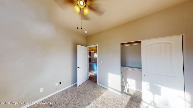 unfurnished bedroom with ceiling fan, a closet, and light carpet