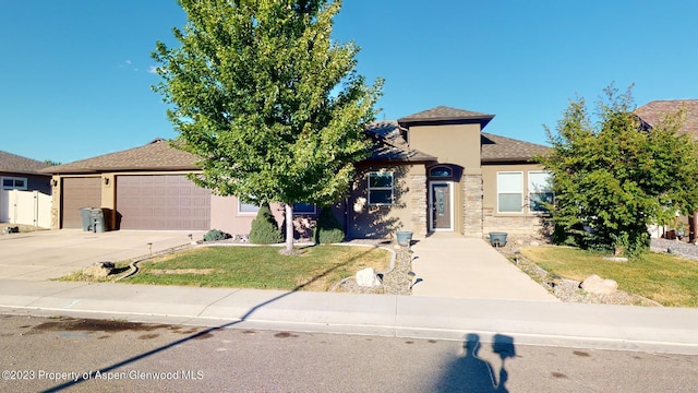 view of front of house with a front yard and a garage