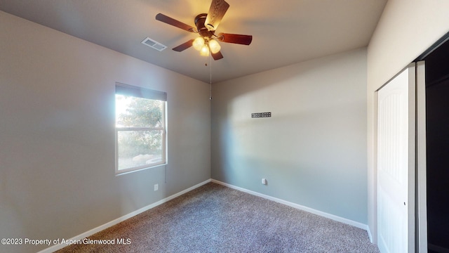 unfurnished room with carpet and ceiling fan