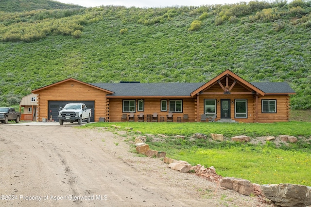 log home with a porch and a garage