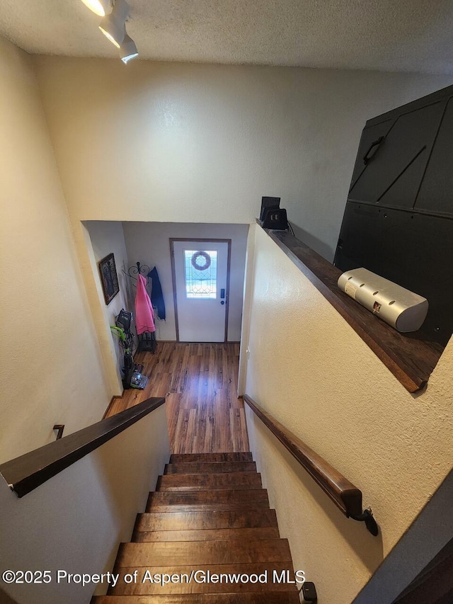 staircase featuring wood finished floors