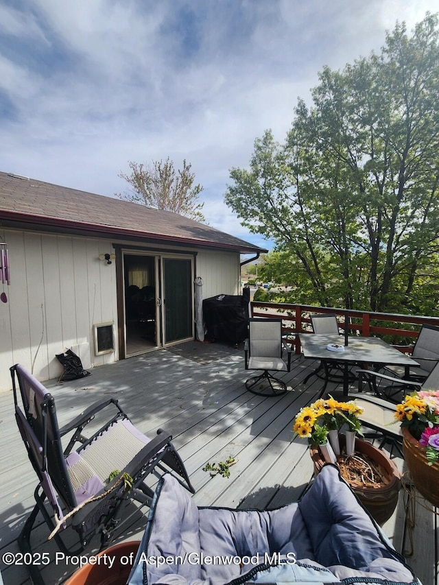 deck with outdoor dining area