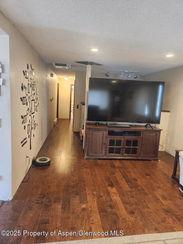 3057 Wellington Ave, Grand Junction, CO 81504 - unfurnished living room with dark wood-style floors and a textured ceiling