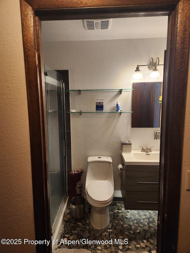 3057 Wellington Ave, Grand Junction, CO 81504 - full bath featuring vanity, a shower stall, and a textured wall