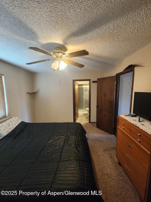 3057 Wellington Ave, Grand Junction, CO 81504 - carpeted bedroom with a textured ceiling, connected bathroom, and ceiling fan