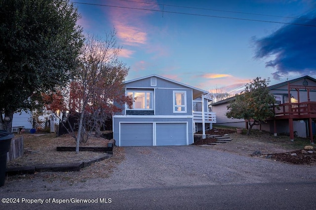 view of front of house featuring a deck and a garage