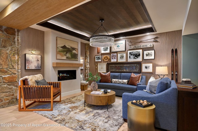 300 Carriage Way Unit 603, Snowmass Village, CO 81615 - living area with a raised ceiling, a fireplace, wood finished floors, wooden ceiling, and wood walls