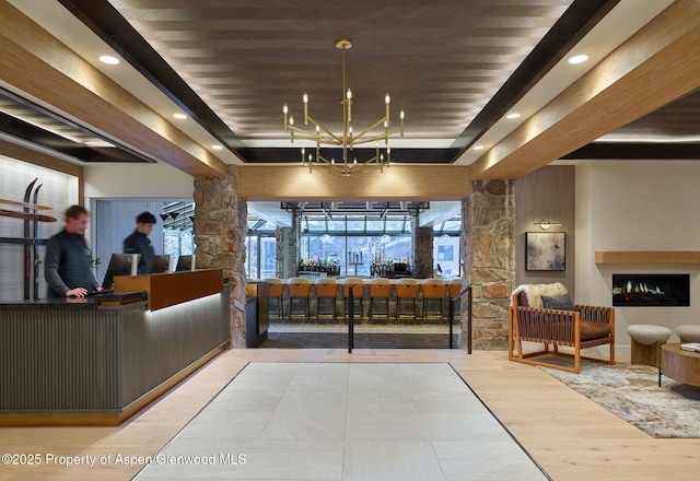 300 Carriage Way Unit 603, Snowmass Village, CO 81615 - reception area with a chandelier, ornate columns, and recessed lighting