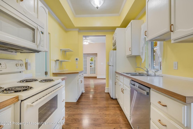 727 Bennett Ave, Glenwood Springs, CO 81601 - kitchen with white appliances, white cabinetry, wood finished floors, light countertops, and crown molding
