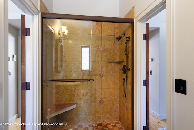 bathroom with a shower with shower door