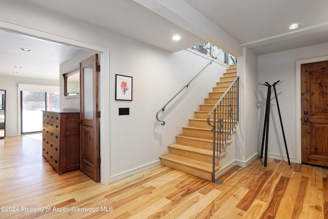 stairway featuring wood-type flooring