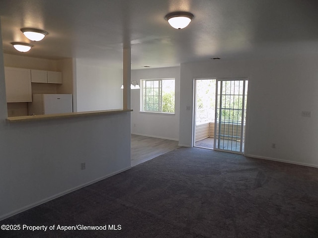 33 Angelica Cir, Parachute, CO 81635 - unfurnished living room with carpet flooring and baseboards