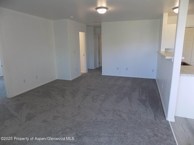 33 Angelica Cir, Parachute, CO 81635 - empty room featuring dark carpet and baseboards