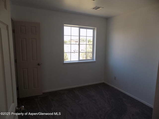33 Angelica Cir, Parachute, CO 81635 - unfurnished room featuring dark colored carpet and baseboards