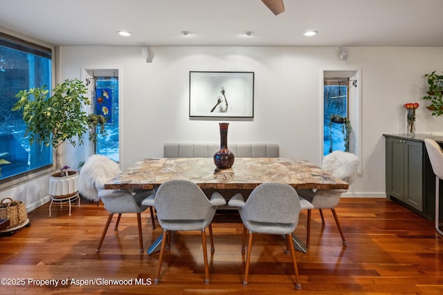 dining room featuring recessed lighting, baseboards, radiator heating unit, and wood finished floors