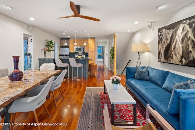 living area featuring a ceiling fan, recessed lighting, and dark wood finished floors