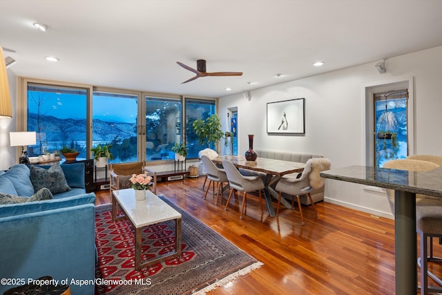 living area with baseboards, a ceiling fan, wood finished floors, and recessed lighting