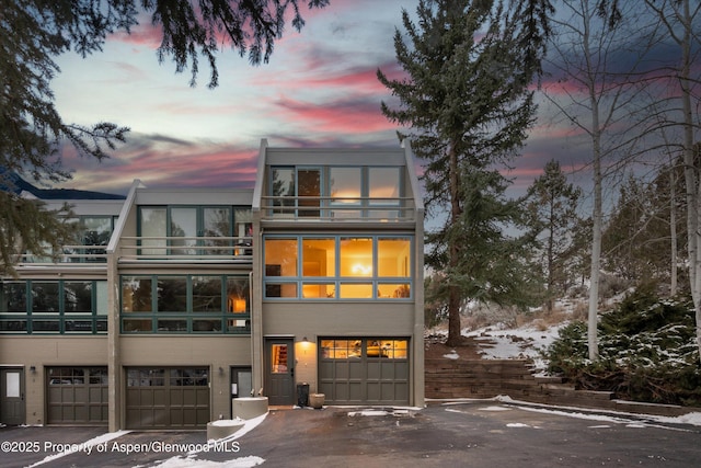 view of front of house featuring a garage and a balcony