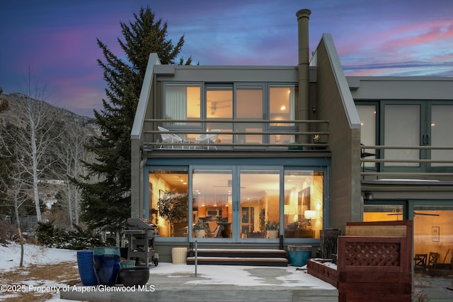 rear view of property featuring a balcony