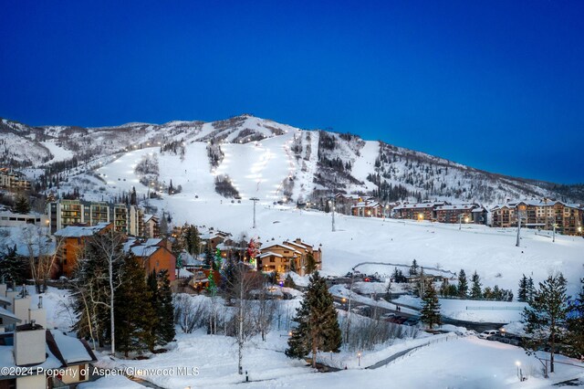 snowy aerial view with a mountain view