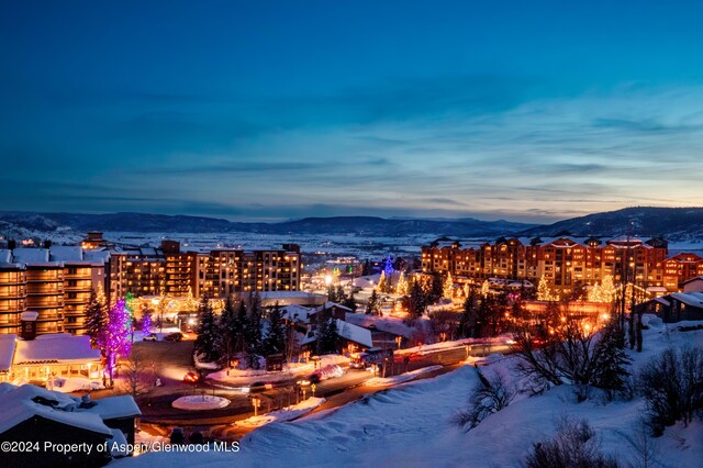 snowy aerial view featuring a mountain view