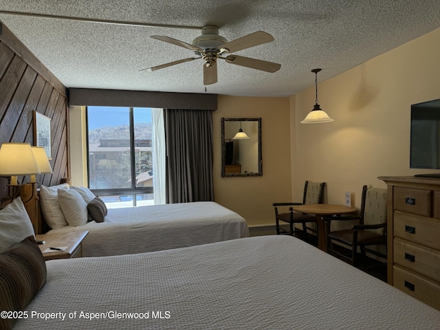 300 Carriage Way Unit 521, Snowmass Village, CO 81615 - bedroom featuring baseboards, a ceiling fan, and a textured ceiling