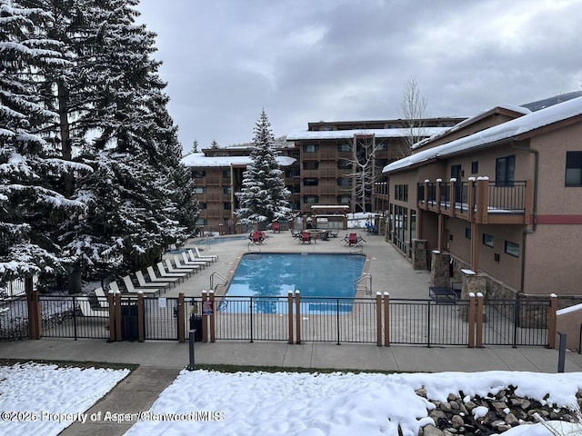 300 Carriage Way Unit 521, Snowmass Village, CO 81615 - snow covered pool with fence, a community pool, and a patio area