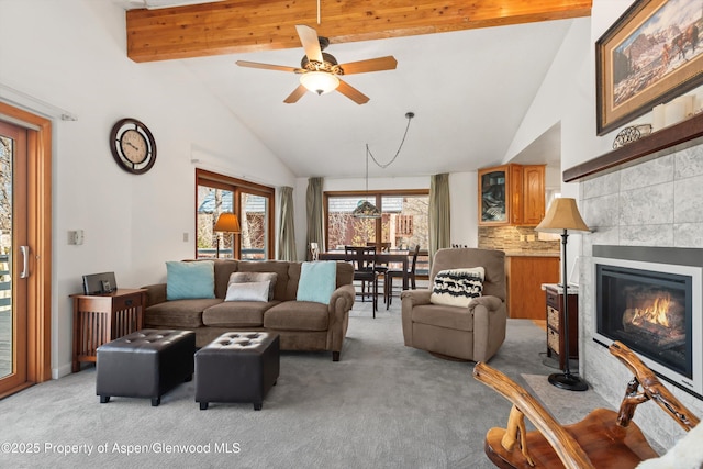 534/536 Spruce St, Aspen, CO 81611 - living room with light carpet, beamed ceiling, ceiling fan, a fireplace, and high vaulted ceiling