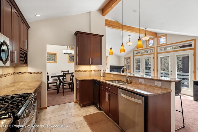 534/536 Spruce St, Aspen, CO 81611 - kitchen featuring stainless steel appliances, a peninsula, a breakfast bar, beam ceiling, and light stone counters