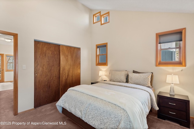 534/536 Spruce St, Aspen, CO 81611 - carpeted bedroom featuring a closet, high vaulted ceiling, and multiple windows