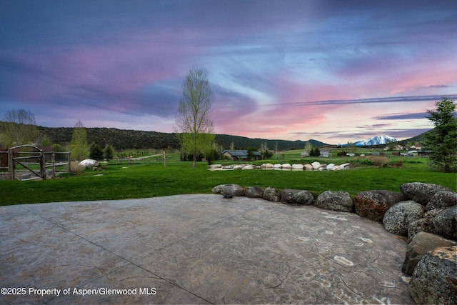 103 Ranch Ln, Glenwood Springs, CO 81601 - patio terrace at dusk with a lawn and a view of rural / pastoral area
