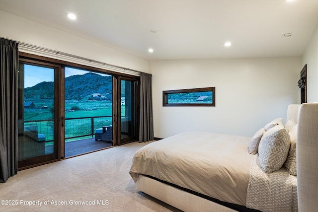 103 Ranch Ln, Glenwood Springs, CO 81601 - bedroom featuring access to exterior, light colored carpet, recessed lighting, multiple windows, and a mountain view