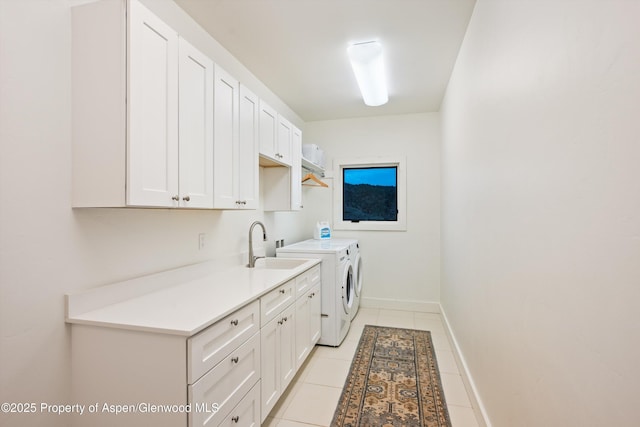 103 Ranch Ln, Glenwood Springs, CO 81601 - clothes washing area with washer and clothes dryer, cabinet space, light tile patterned floors, and baseboards