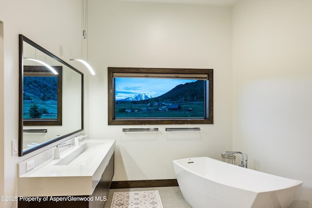 103 Ranch Ln, Glenwood Springs, CO 81601 - bathroom with a freestanding tub, baseboards, tile patterned flooring, and vanity