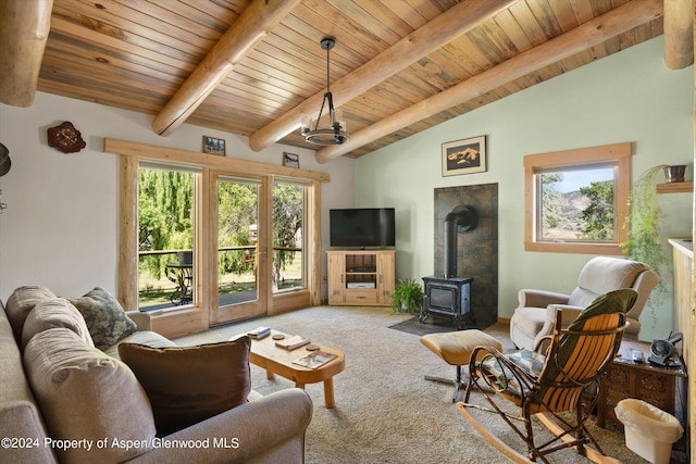 carpeted living room featuring vaulted ceiling with beams, a wood stove, and wooden ceiling