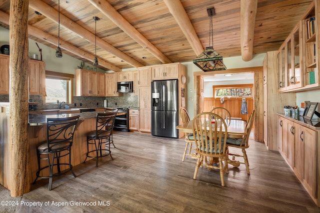 kitchen featuring dark wood-type flooring, tasteful backsplash, lofted ceiling with beams, wood ceiling, and appliances with stainless steel finishes