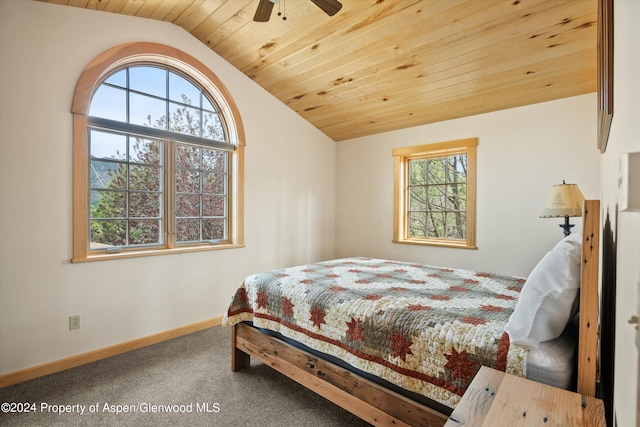 carpeted bedroom with multiple windows, vaulted ceiling, ceiling fan, and wooden ceiling