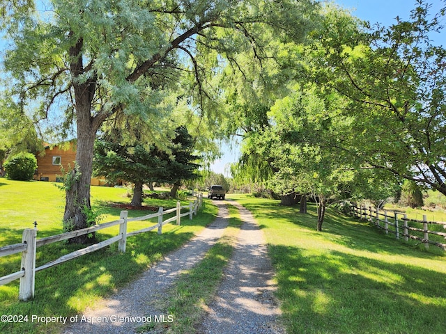 view of property's community featuring a yard and a rural view