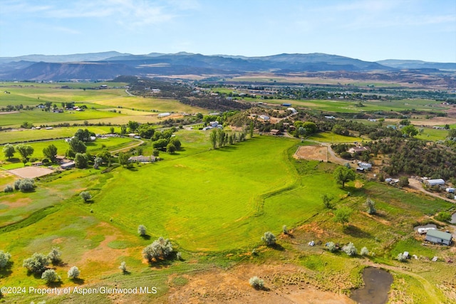 birds eye view of property with a mountain view and a rural view