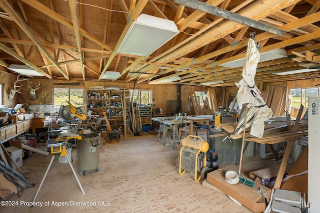 miscellaneous room with a workshop area and vaulted ceiling