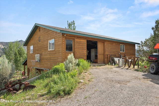 back of property with an outdoor structure