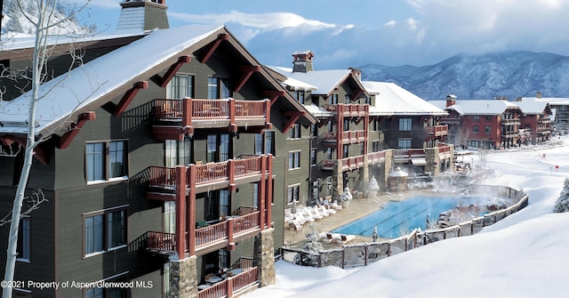 snow covered building with a mountain view