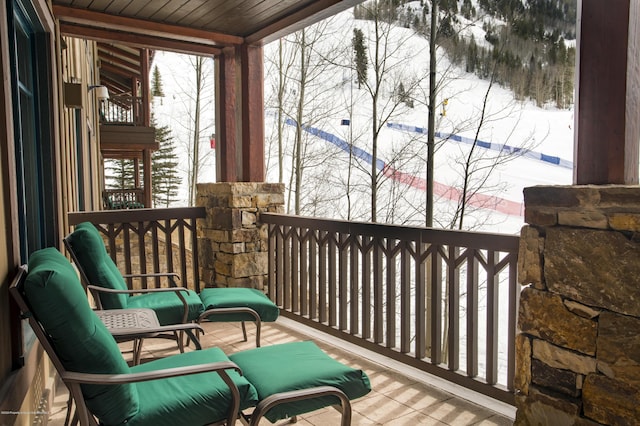 view of snow covered back of property