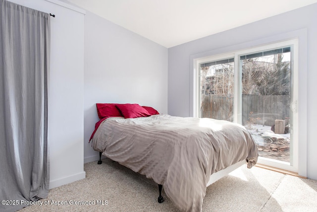 carpeted bedroom featuring access to exterior