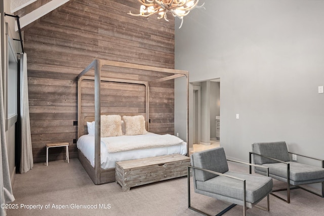 carpeted bedroom featuring beam ceiling, high vaulted ceiling, and a notable chandelier