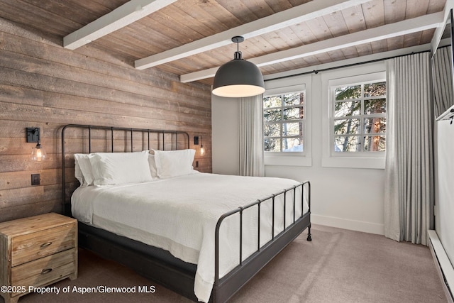 bedroom featuring beam ceiling, a baseboard heating unit, carpet floors, and wooden walls