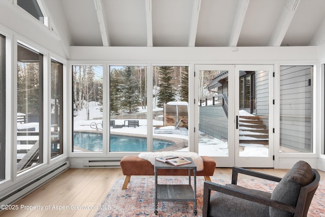 sunroom / solarium featuring baseboard heating and vaulted ceiling with beams